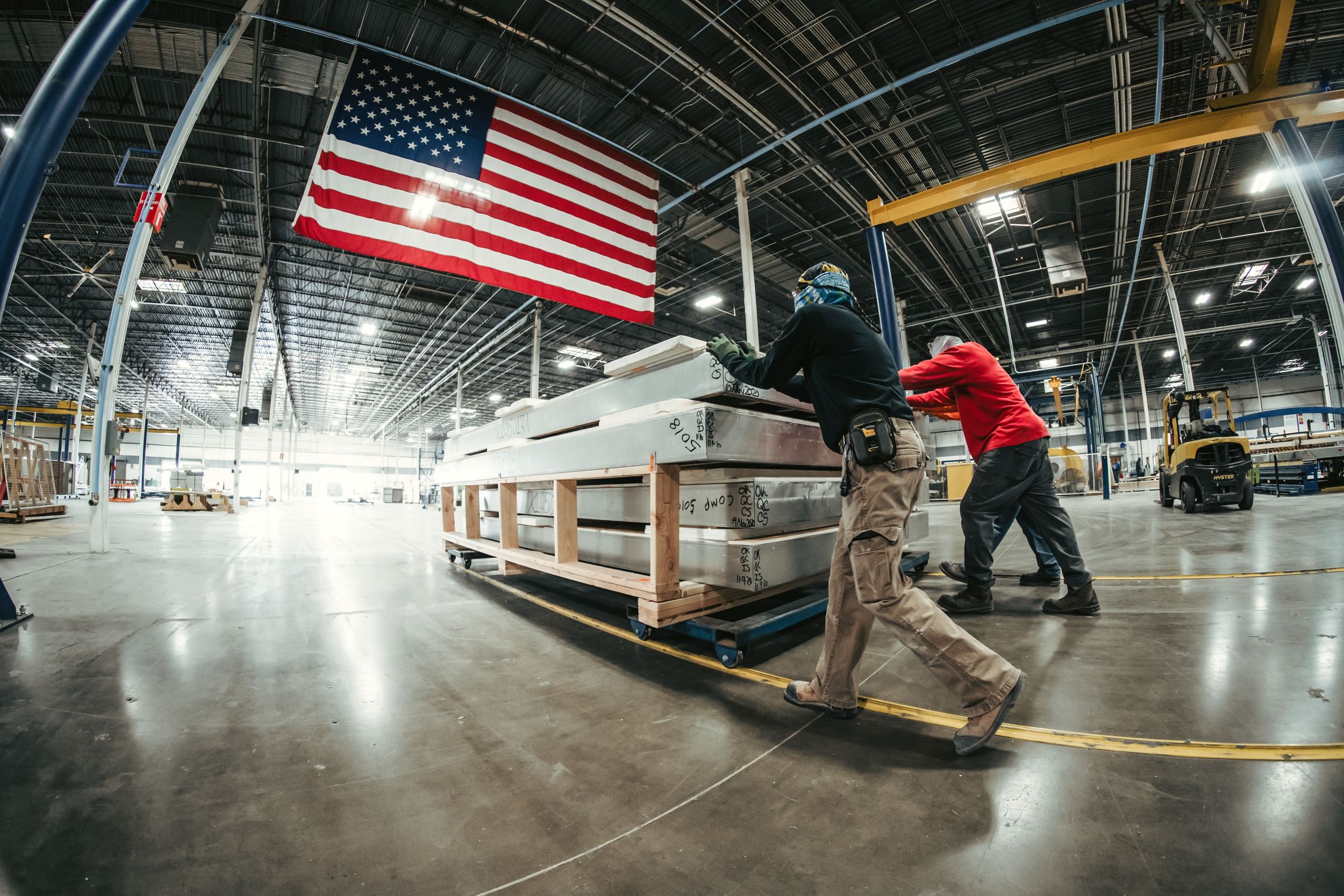 DBC employees pushing pallet of prefabricated panels through Phoenix facility