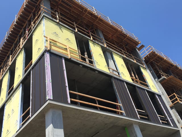 100/150 Hooper building during installation of prefabricated exterior panels