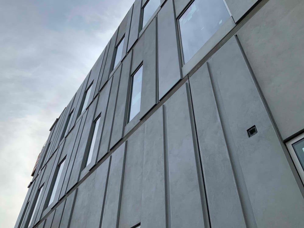 close up of grey EIFS prefabricated panels with windows
