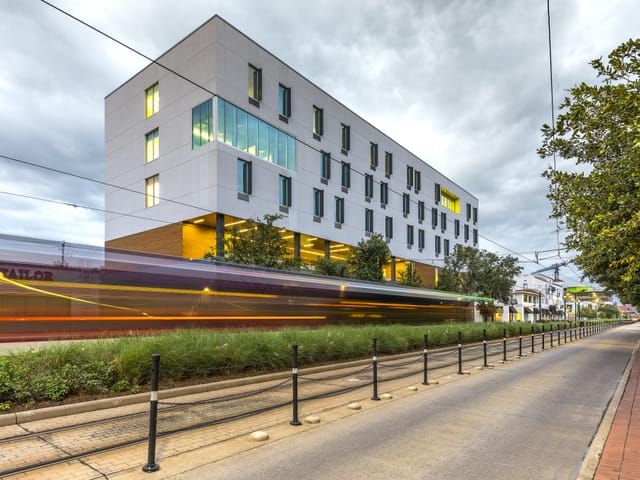 Street view with light rail in foreground; ReCenter street/side view
