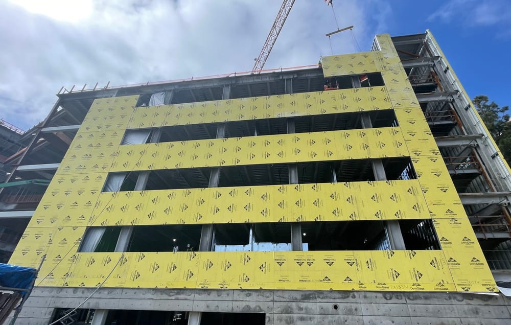 Sheathed exterior panel installation with panel flying