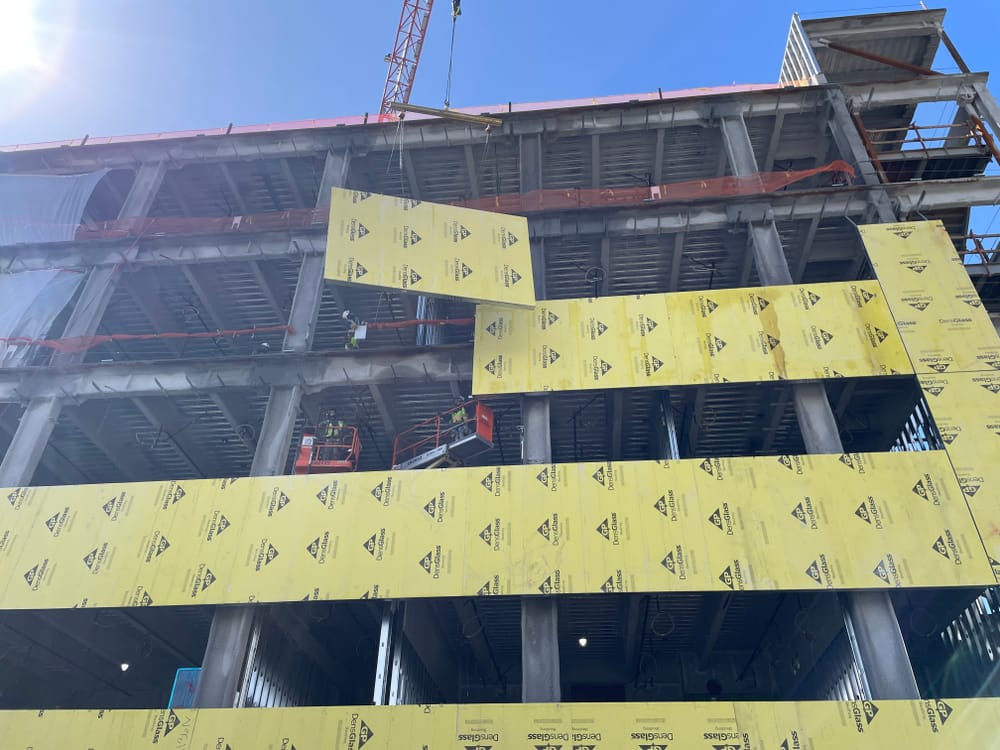 Prefabricated panel hanging by crane during installation