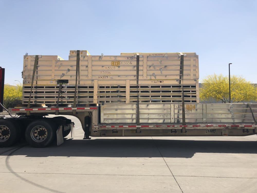 DBC's prefabricated exterior panels stacked and secured on delivery truck bed