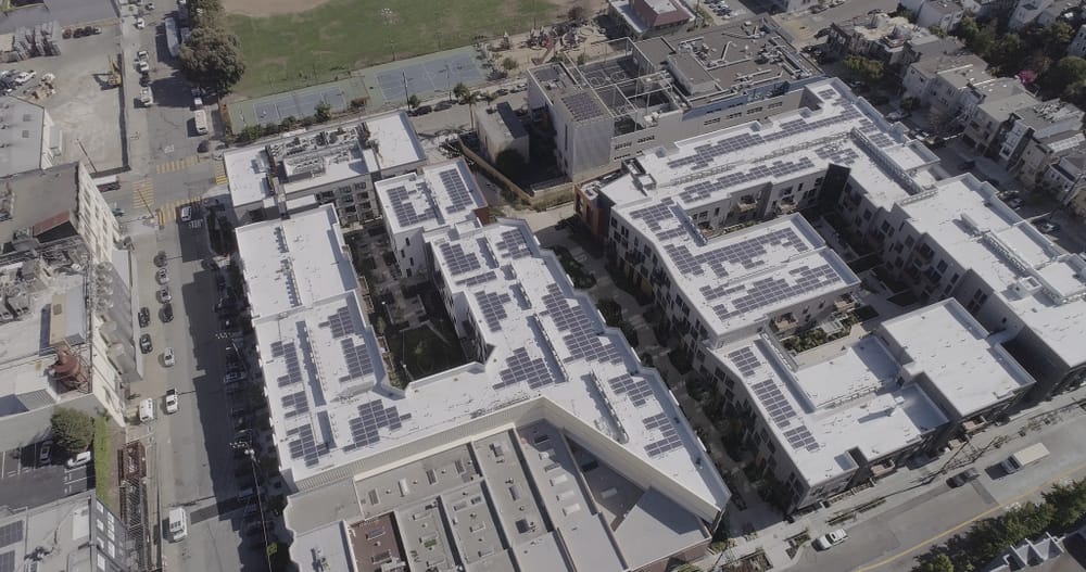 aerial shot of a building with solar panels on the roof