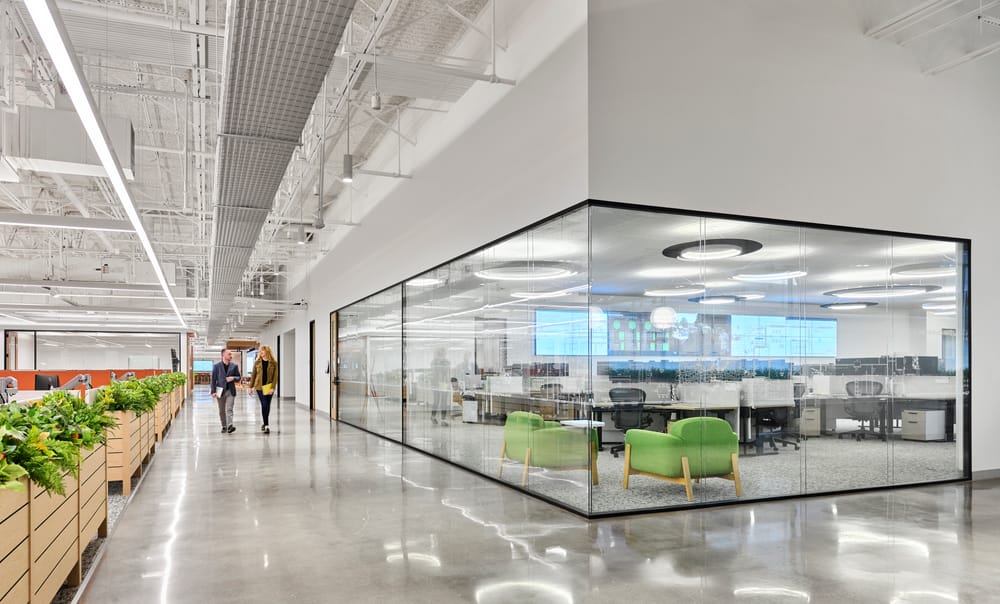 corner view of a conference room with glass walls windows and a hallway
