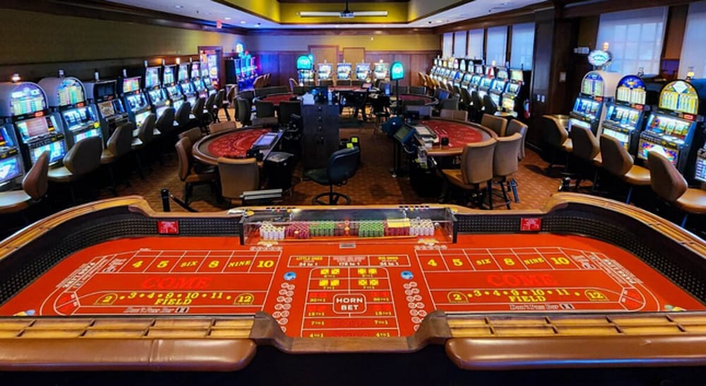 A casino floor with slot machines and game tables
