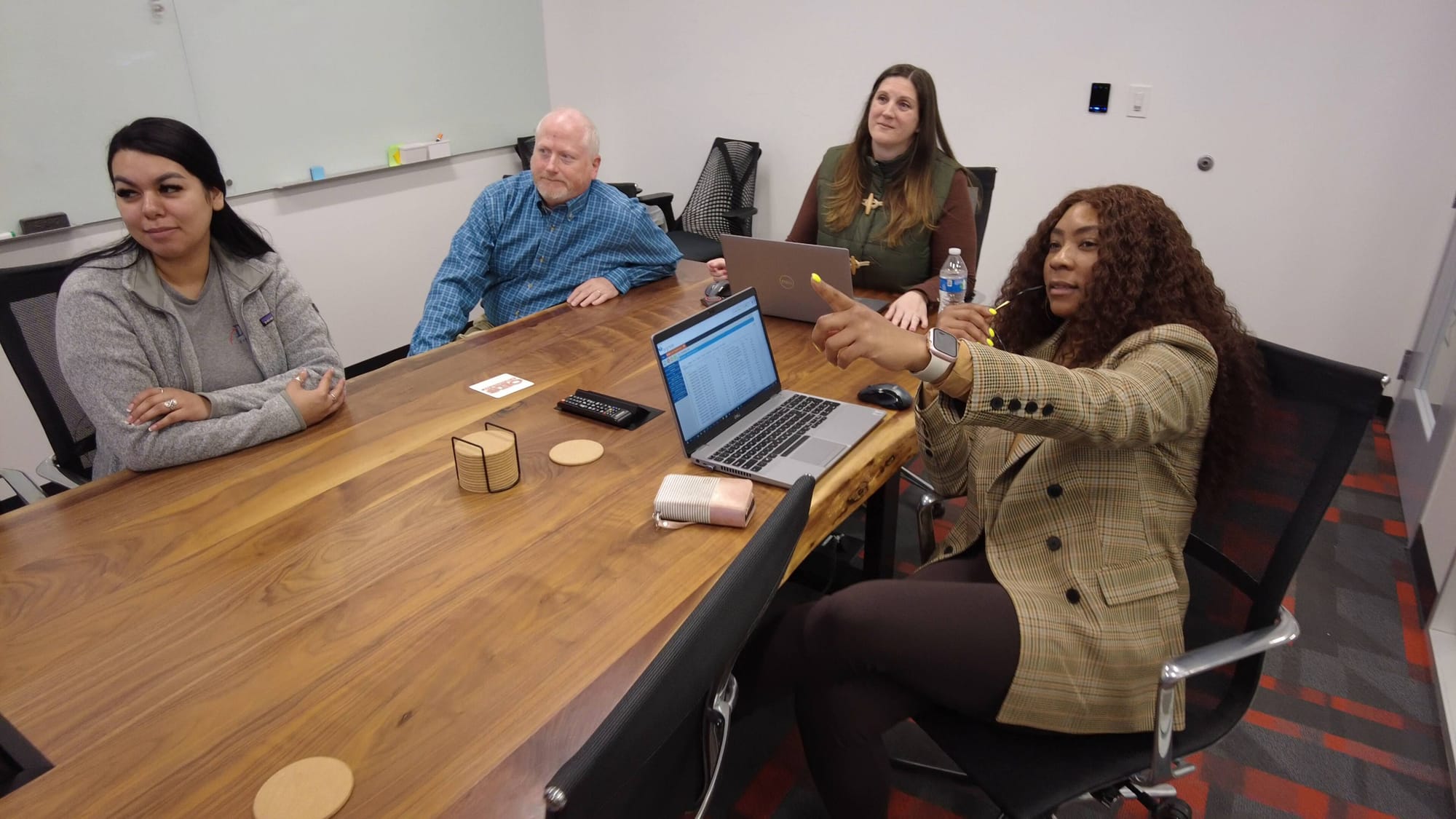 group of employees sitting around a conference table