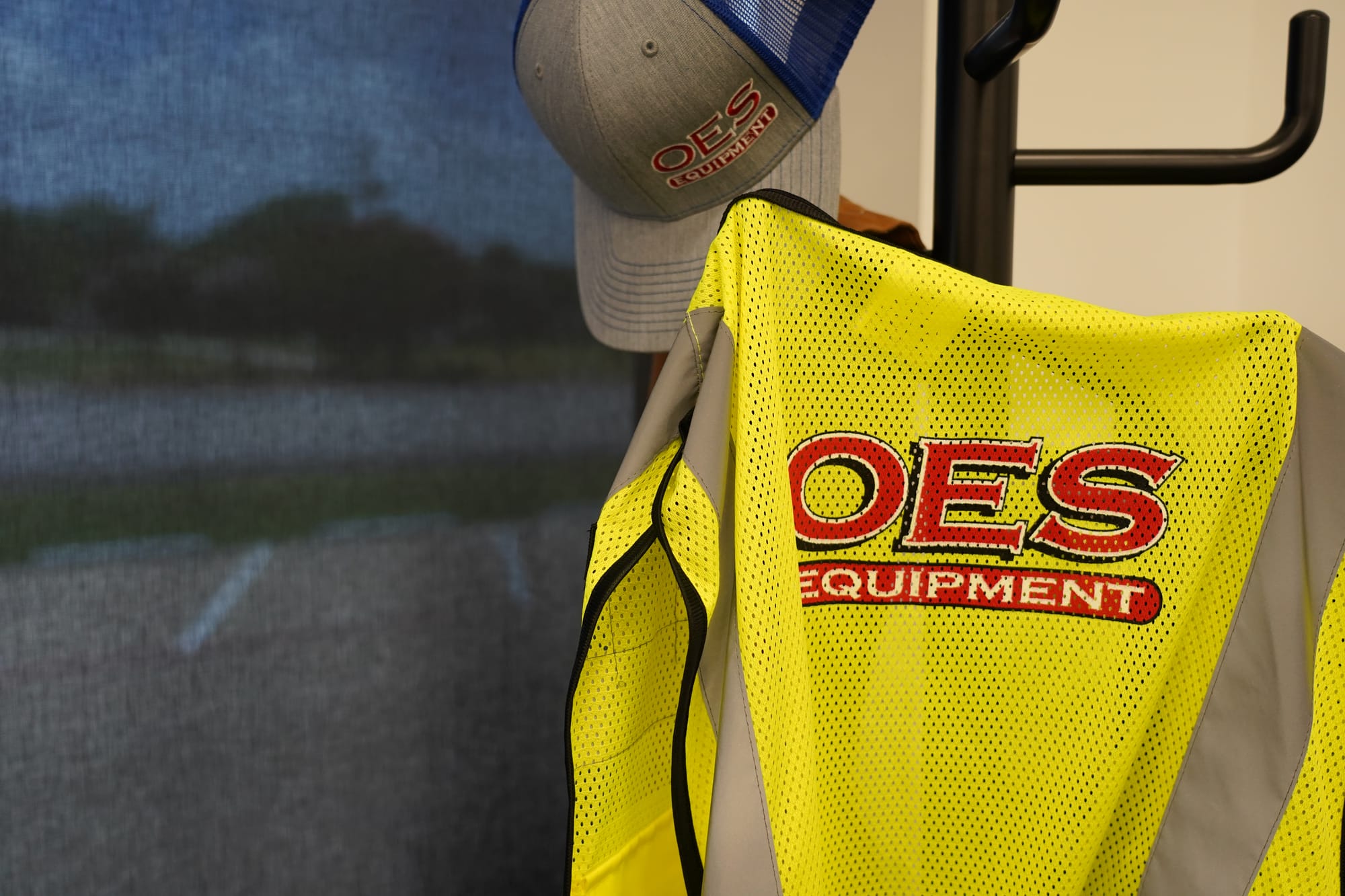 close-up of a yellow safety vest with a red OES logo on the back