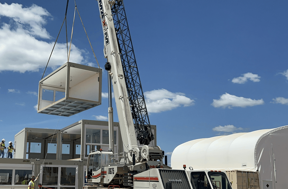 A modular office being lowered from a crane