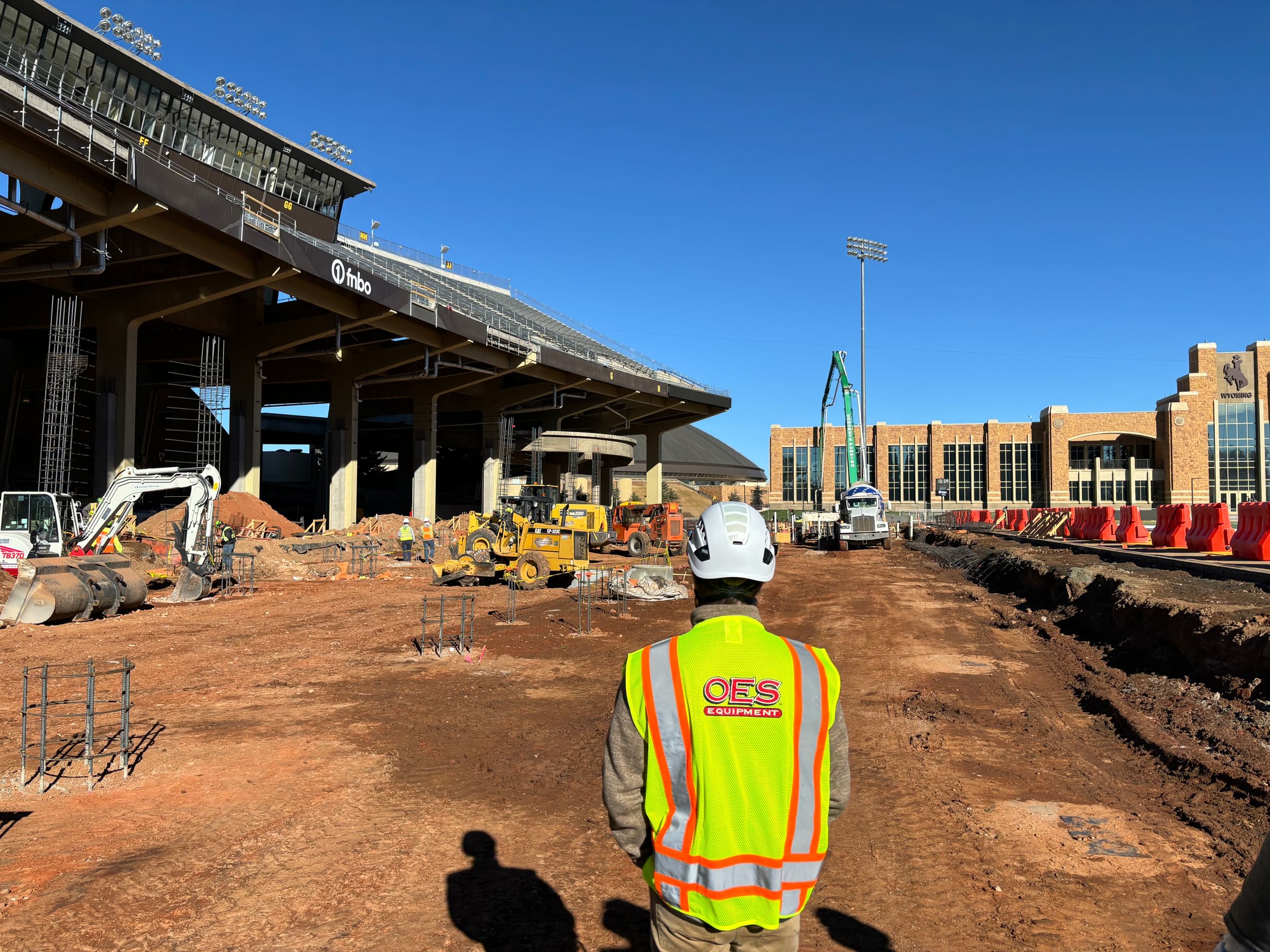 construction worker in full ppe looking at the construction site