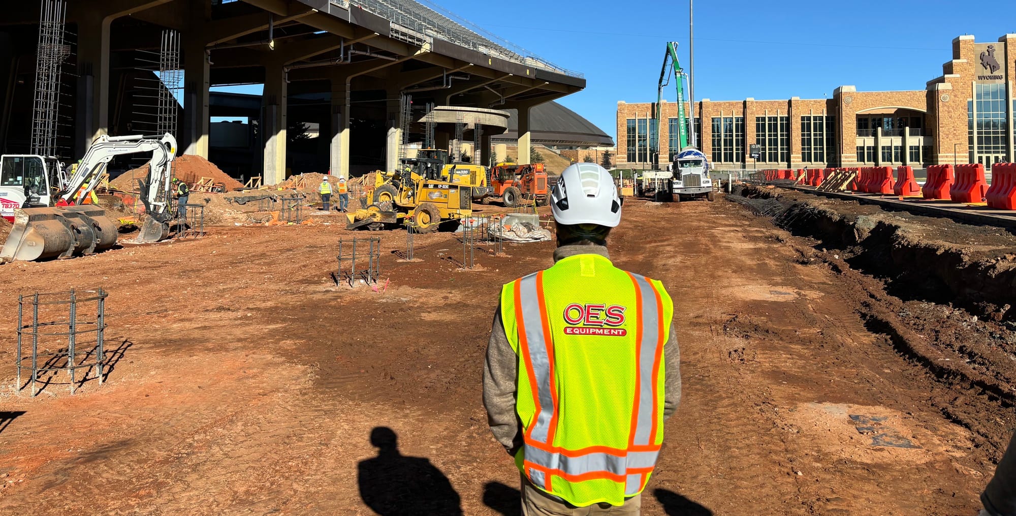 worker in full ppe looking out at a construction site