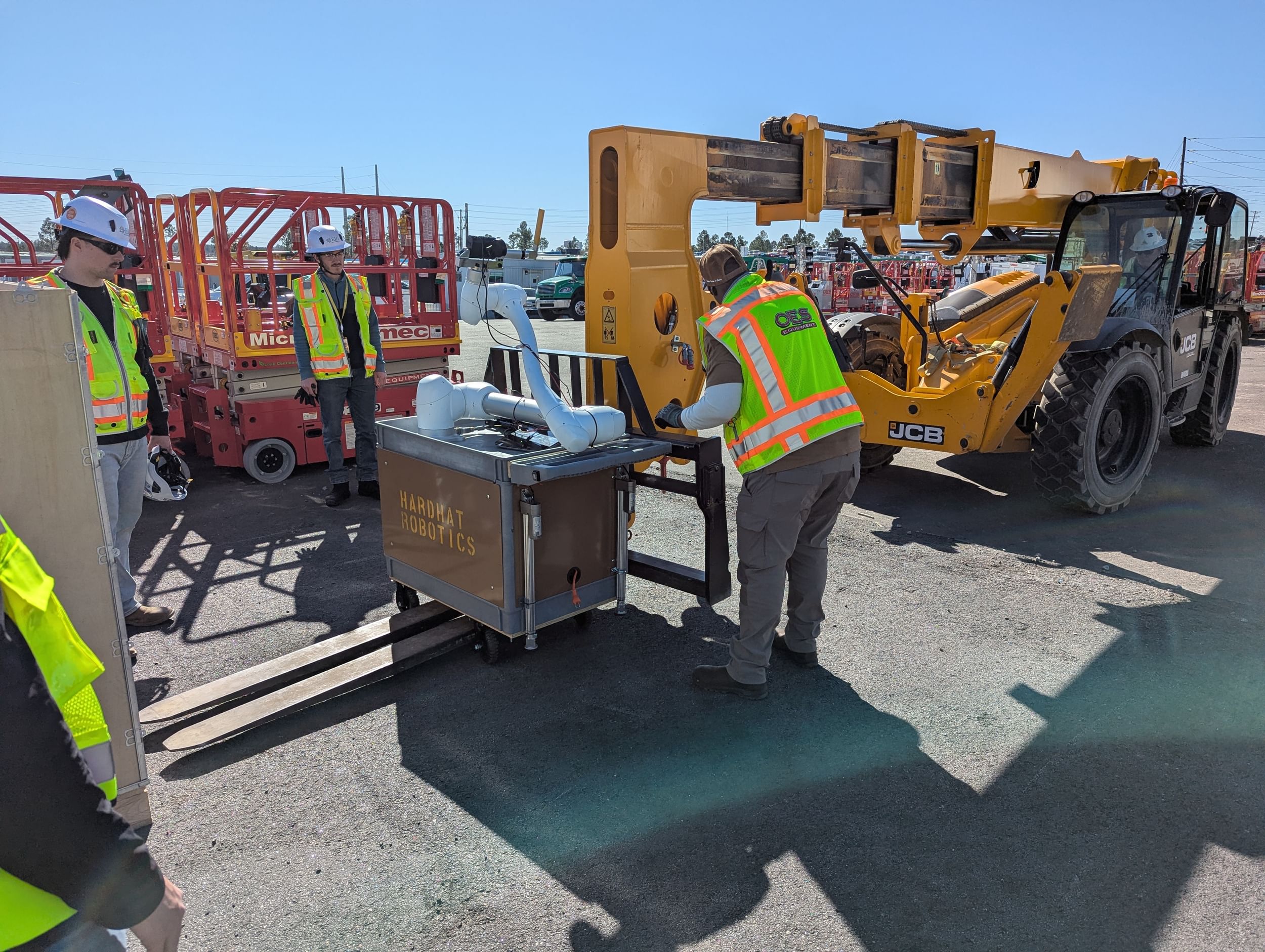 OES team members help with the delivery of Sparky the robot