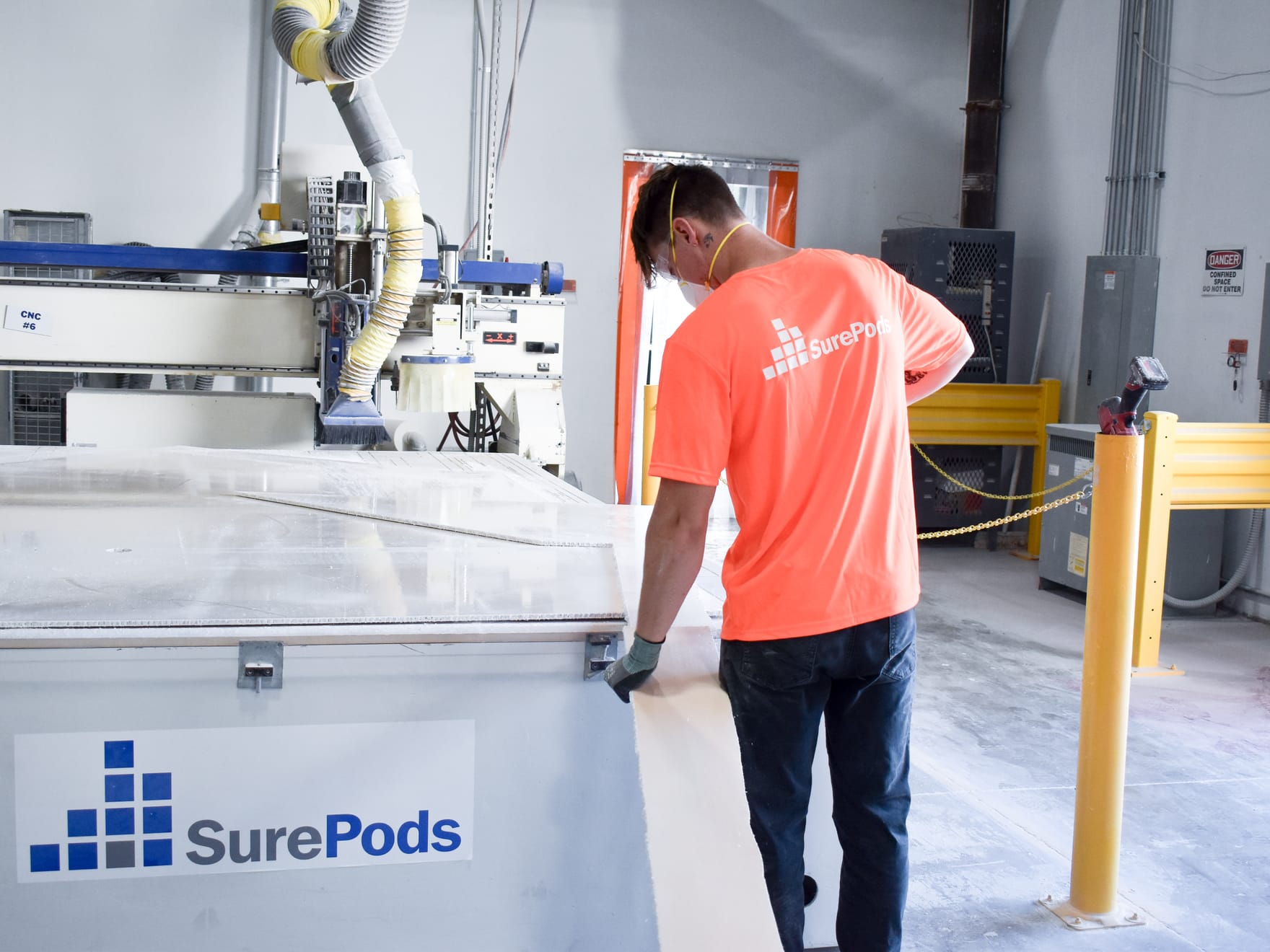employee in the facility working on the production of a surepods unit