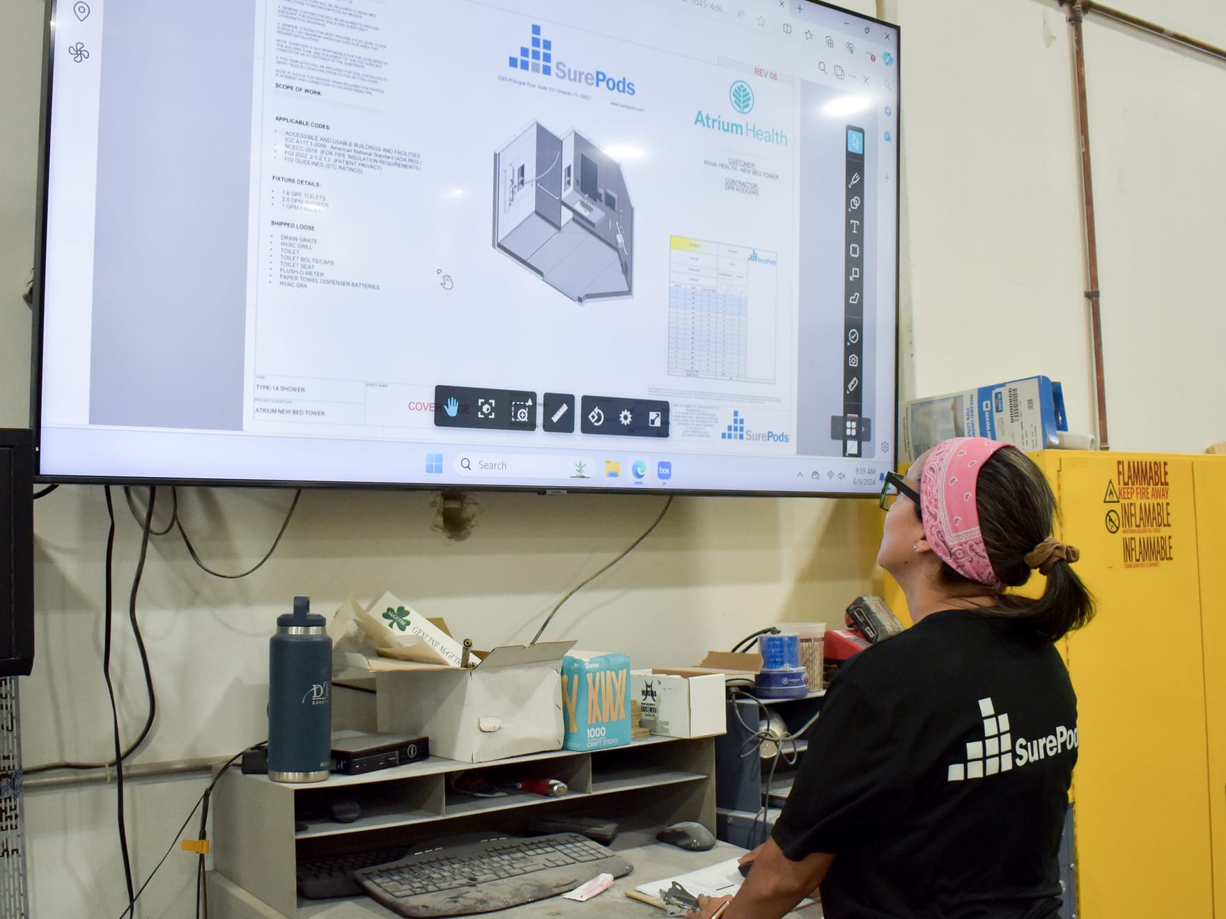 an employee working on the design step of the surepods process