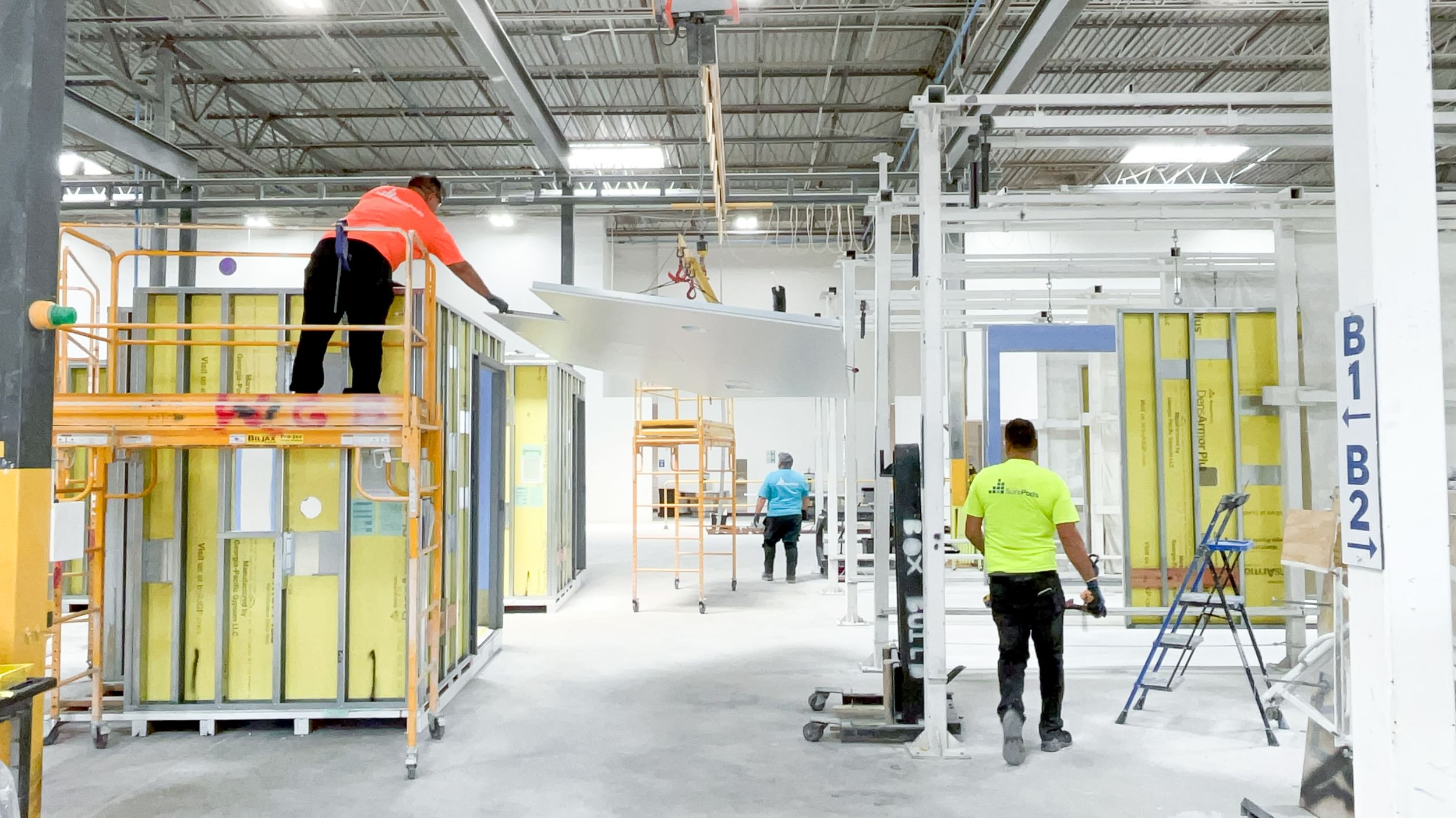 Construction workers inside factory