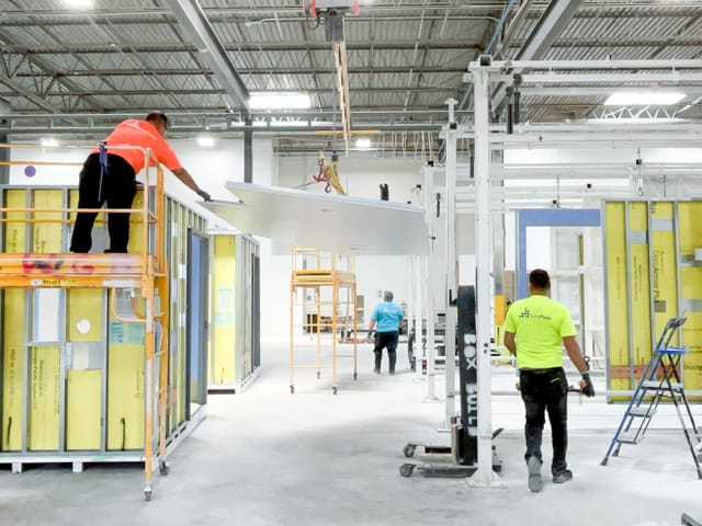 Construction workers inside factory