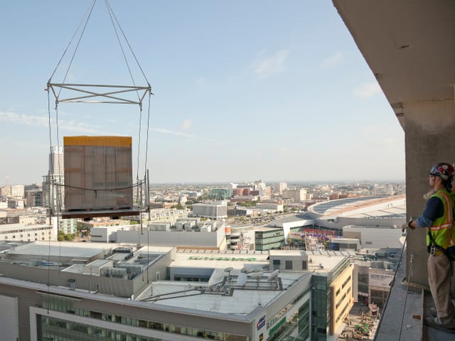 Bathroom pod lifted and flying over city