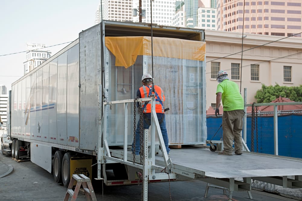 Bathroom pods in truck being offloaded