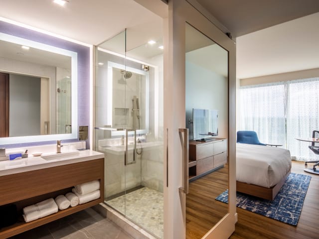 Full view of hotel room with bedroom, and bathroom