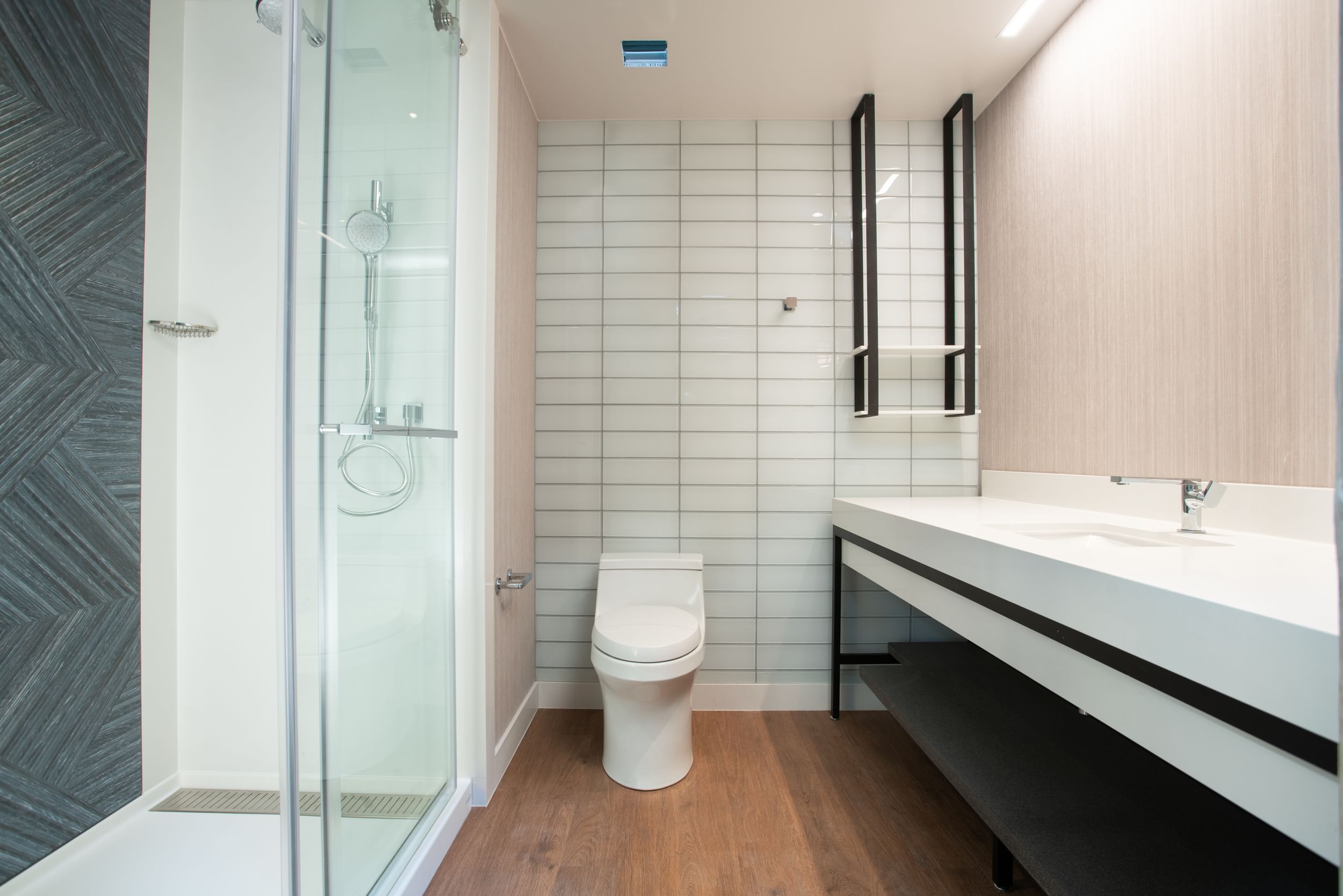 Finished bathroom picture of shower, toilet and vanity