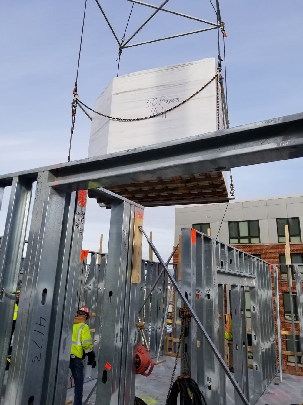 construction workers installing bathroom pods