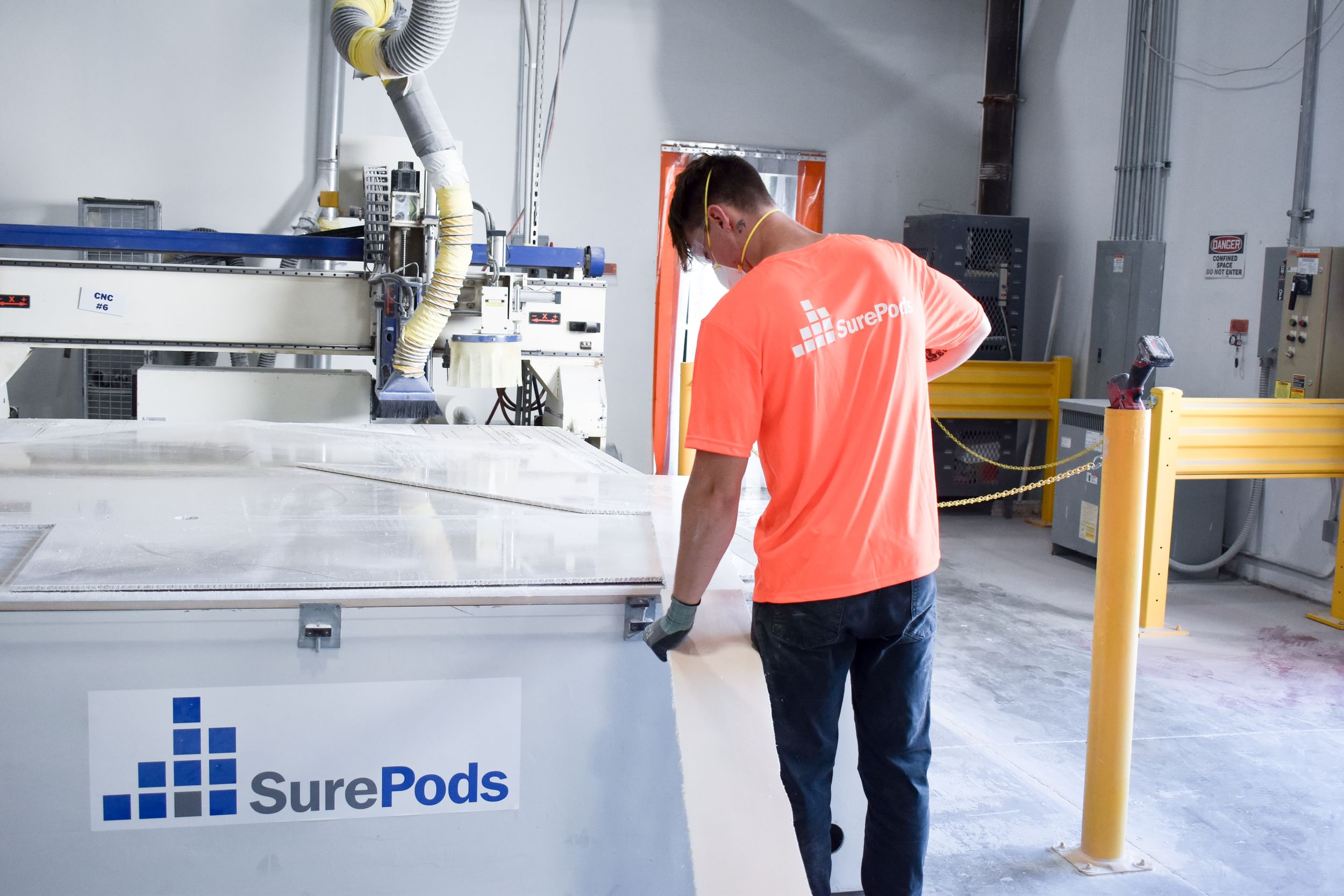 employee in the facility working on the production of a surepods unit