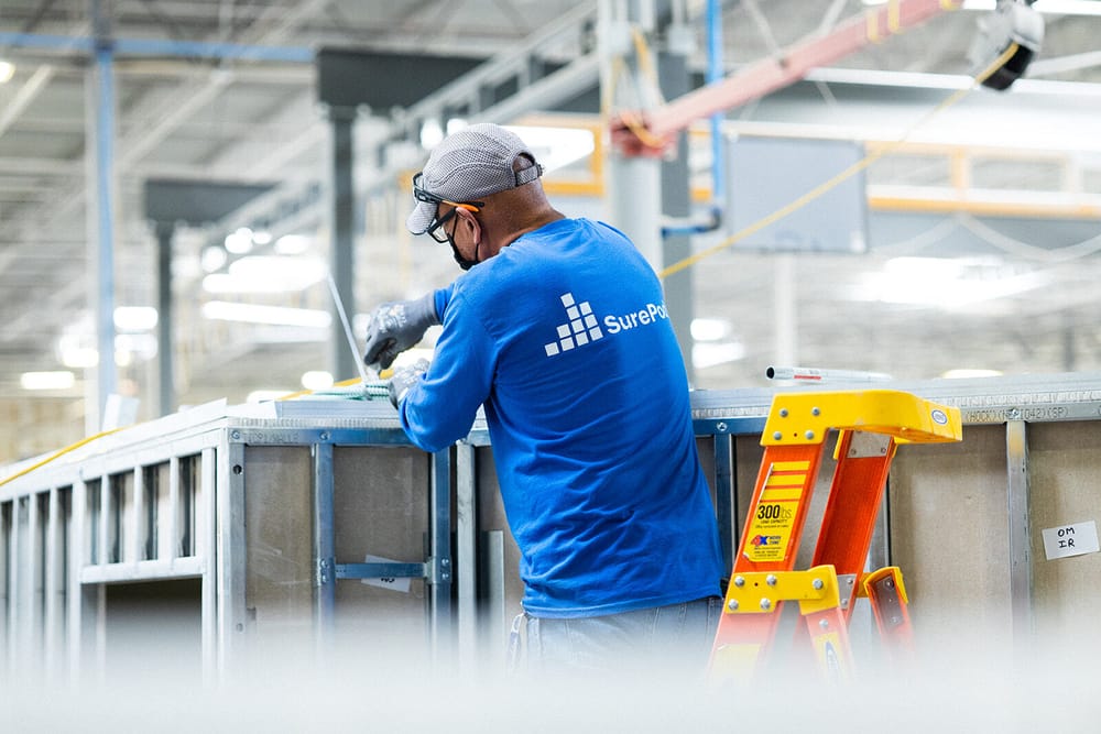 A SurePods teammate building a SurePod.