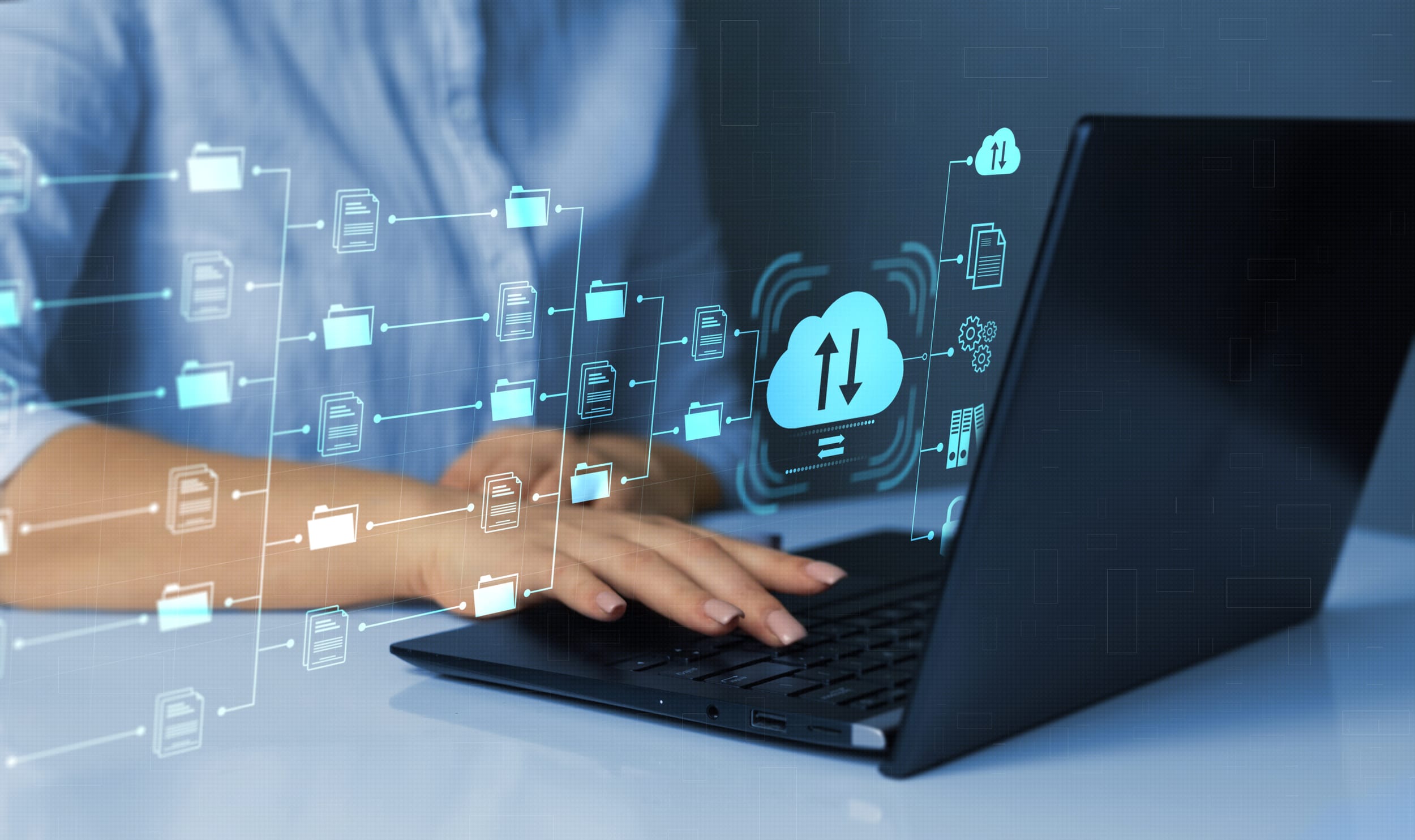 A female is working on a laptop and the image is overlayed with a digital network of files.