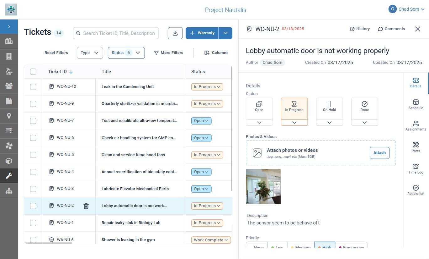 Screenshot of VueOps work order management dashboard showing a list of maintenance tickets on the left and details of a selected ticket on the right. The highlighted ticket reports a lobby automatic door not working properly, with status set to 'In Progress,' author information, attachments, photos, and a description noting a sensor issue.