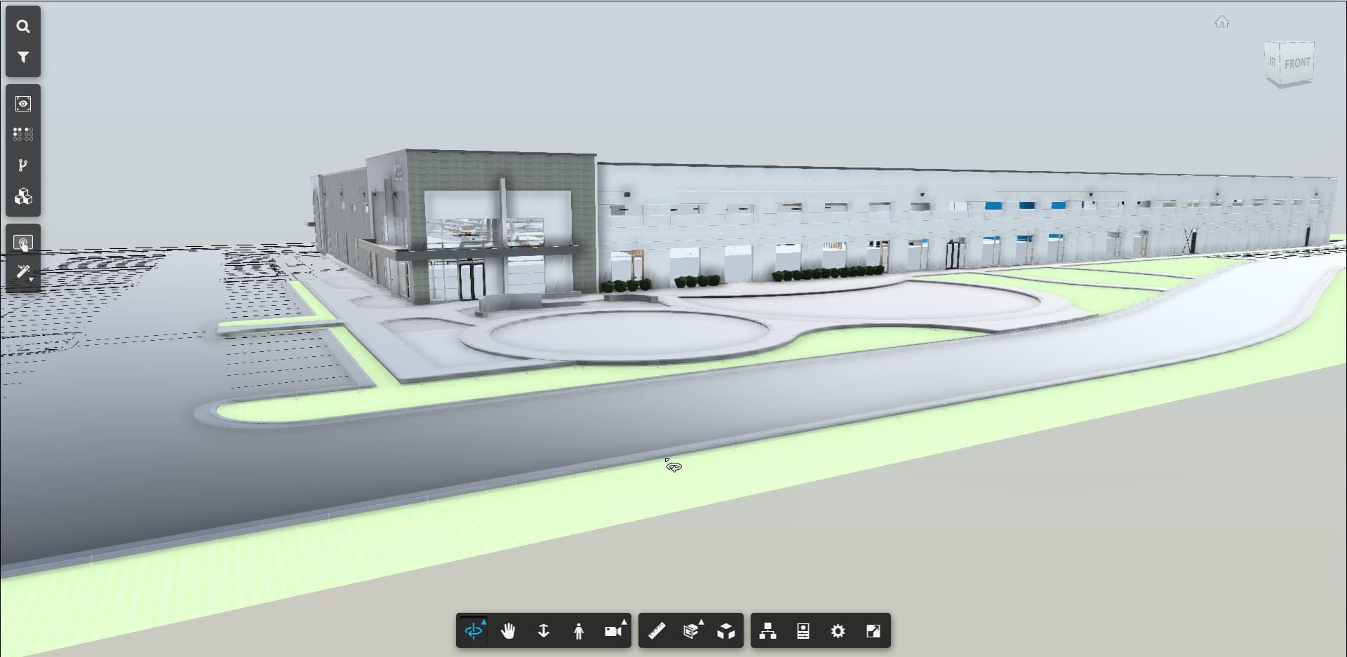 3D digital model of a large industrial or commercial building viewed from the exterior, showing the main entrance, surrounding roads, parking areas, and landscaping. The model interface includes navigation and viewing tools on the left and bottom of the screen.