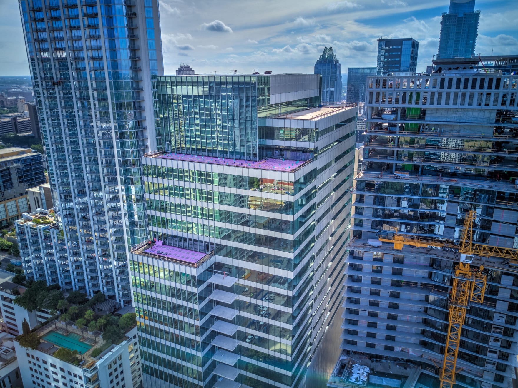 Multiple buildings, tall skyscrapers in a dense city center